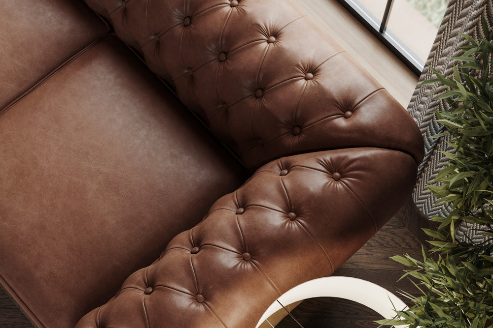 In a Living Room, There is Half Right-Side's Top Angle Close-Up View of A Luxurious, Dark Chocolate, Parma 64" Top Grain Leather Chesterfield Loveseat Sofa.